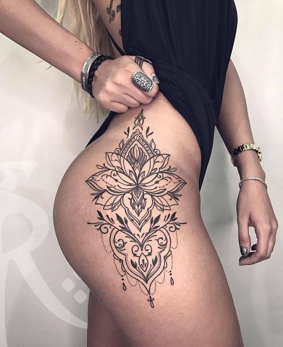 Super hot black lotus flower tattoo on the right hip and thigh