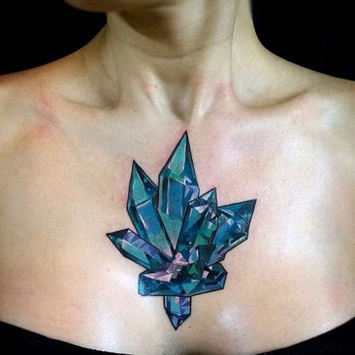 Teal blue crystal cluster tattoo on the chest