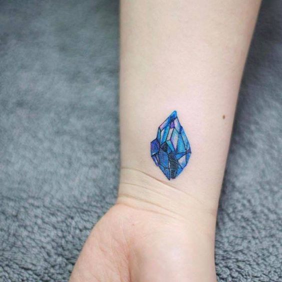 Tiny sapphire tattoo on the right inner wrist