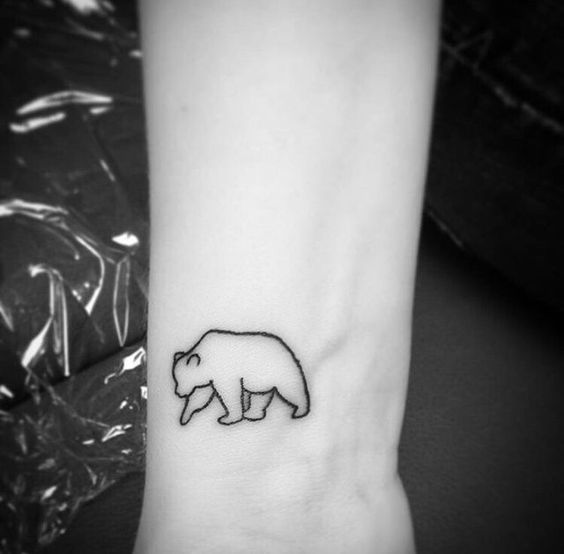 Tiny outline bear wrist tattoo