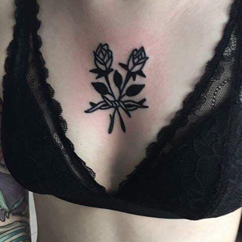 Traditional black roses on the sternum