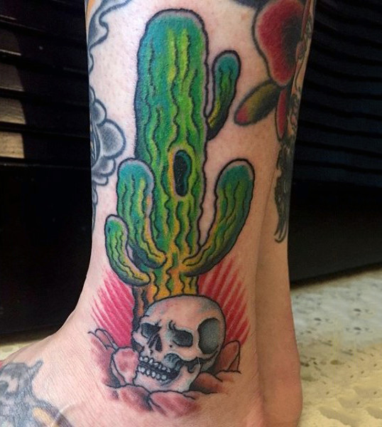 Traditional cactus and skull tattoo on the left outer ankle