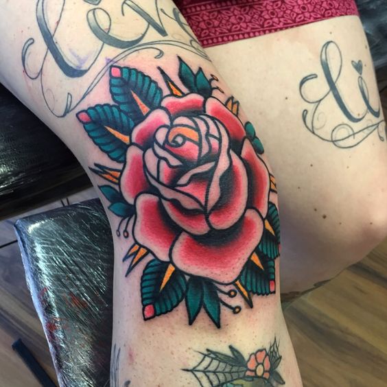 Traditional red rose tattoo on the right knee by kelly smith