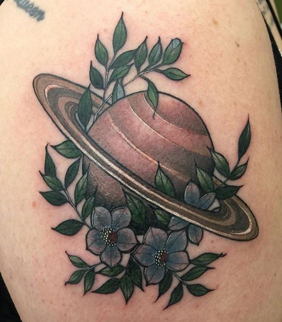 Traditional saturn with flowers tattoo