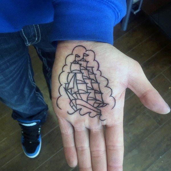 Traditional ship tattoo on the left palm