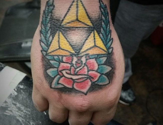 Traditional style triforce and rose tattoo on the hand
