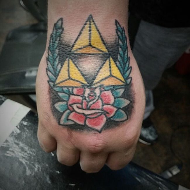 Traditional style triforce and rose tattoo on the hand