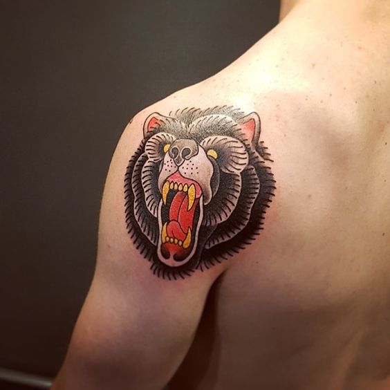Traditional tattoo of bear's head on the left shoulder