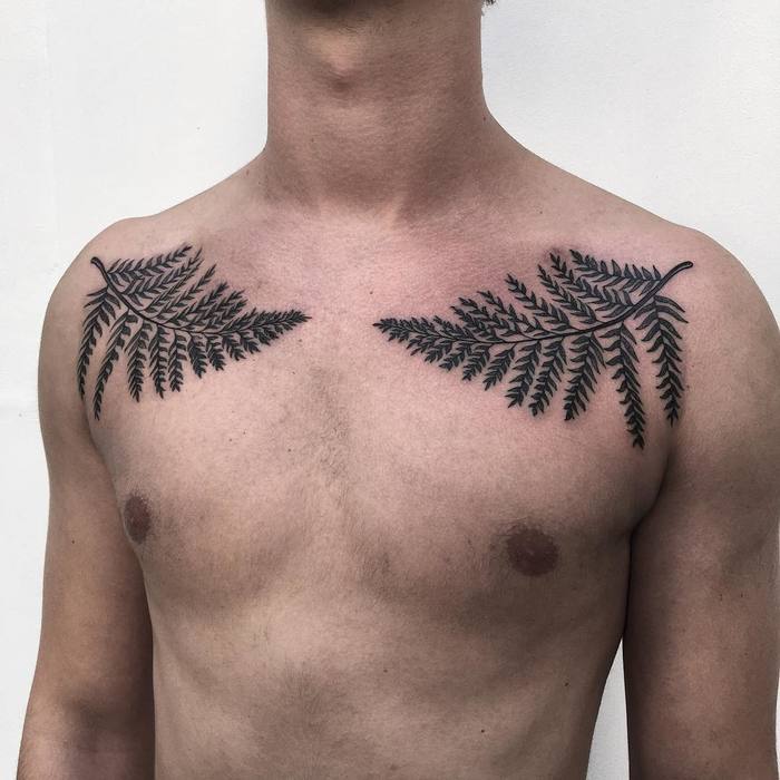 Two black ferns tattoo on both sides of the chest