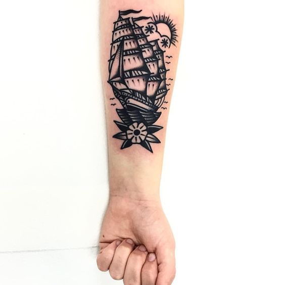 Two masted barque ship with a flower tattoo on the left inner arm