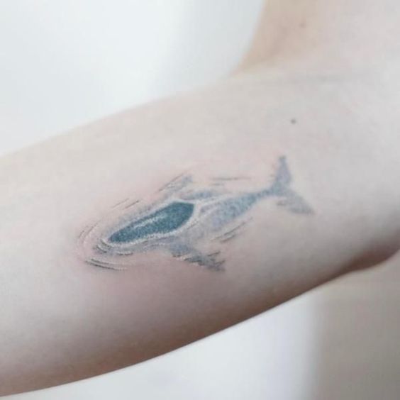 Underwater shark tattoo on the arm