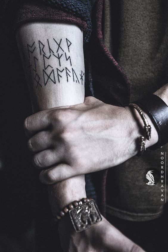Viking runes tattoo on the right inner arm