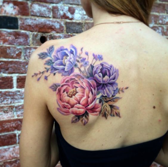 Violet and pink peonies tattoo on the left shoulder blade