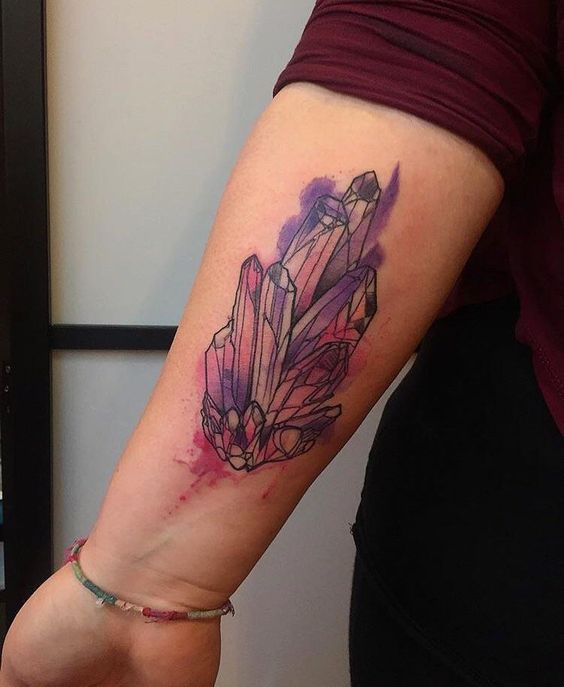 Watercolor amethyst tattoo on the left forearm