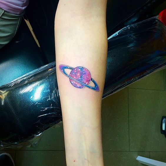 Watercolor saturn with cosmic landscape tattoo