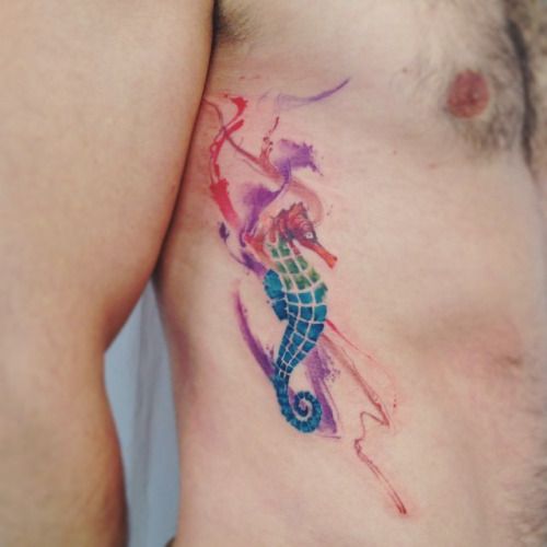 Watercolor seahorse tattoo on the right rib cage