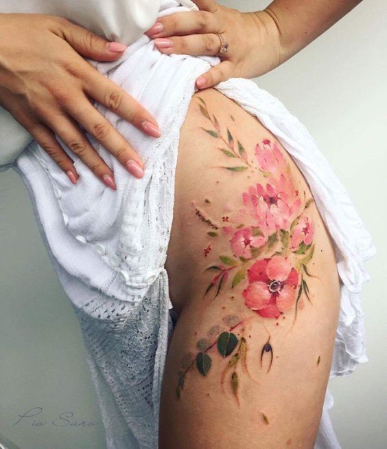 Wildflower tattoo on the left hip and thigh by Pis Saro