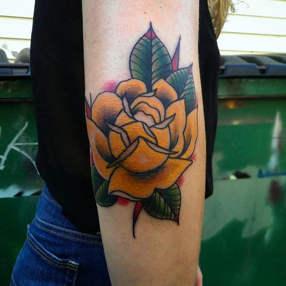 Yellow rose tattoo on the right elbow
