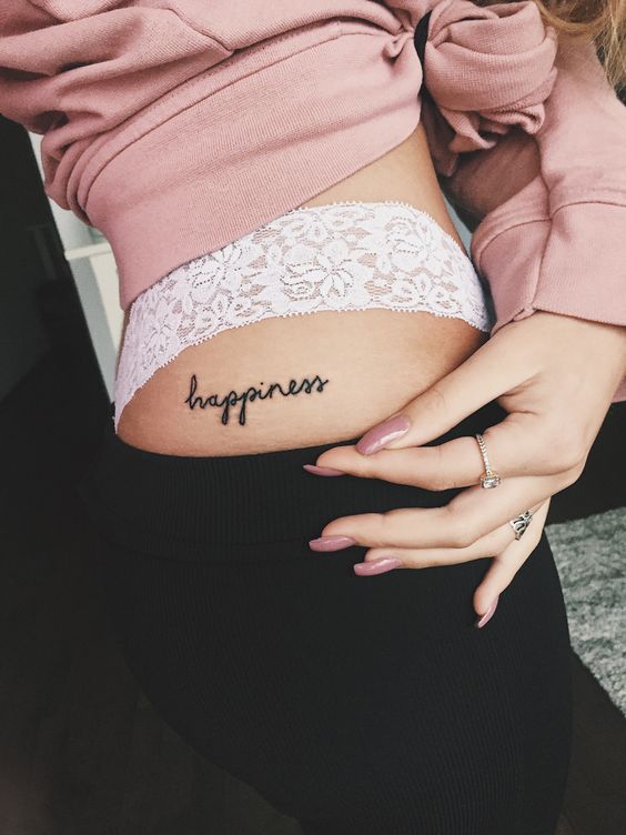 happiness tattoo on the left hip