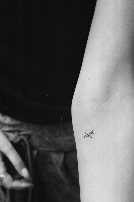 Absolutely gorgeous small airplane tattoo on the forearm