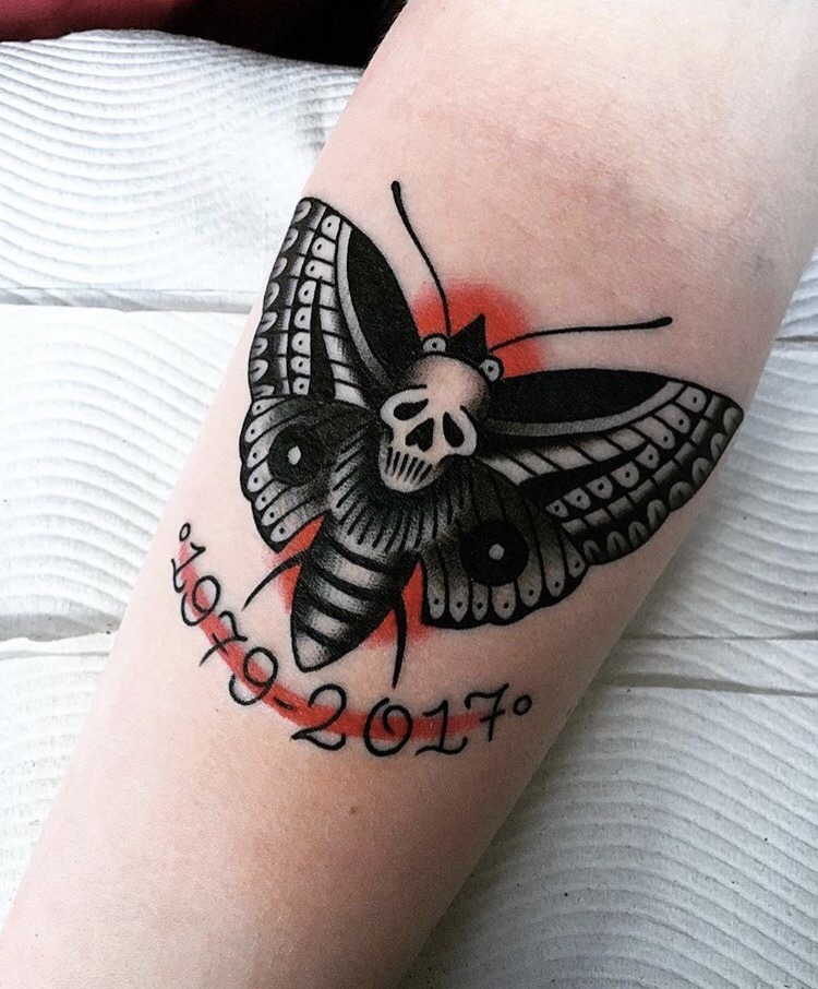 American traditional moth tattoo on the arm