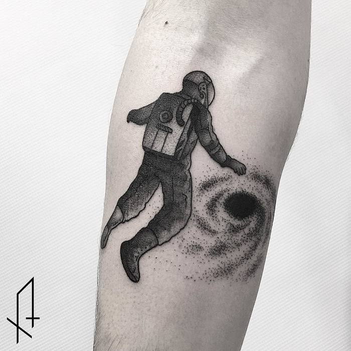 Astronaut falling into black hole tattoo by gioele cassarino