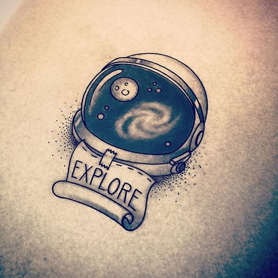 Astronaut helmet tattoo with the reminder to explore