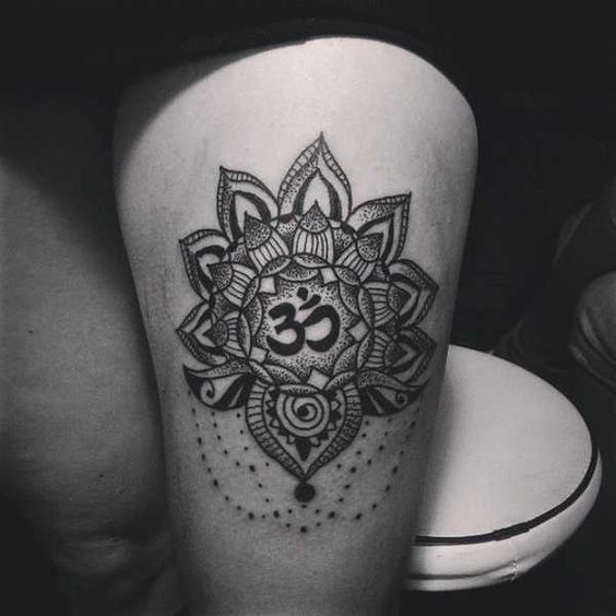 Black dotwork lotus flower and om tattoo on the left thigh
