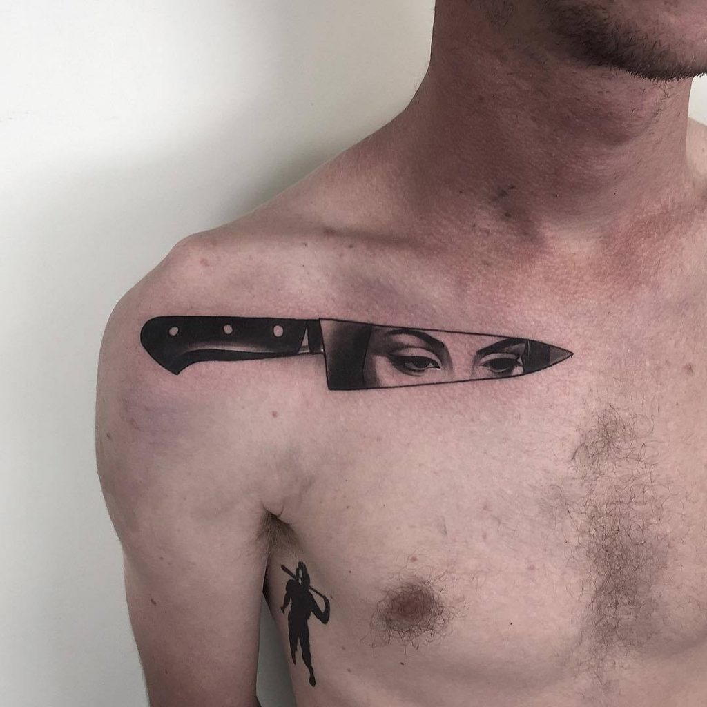 Black knife tattoo with the reflection of a girl eyes by pari corbitt