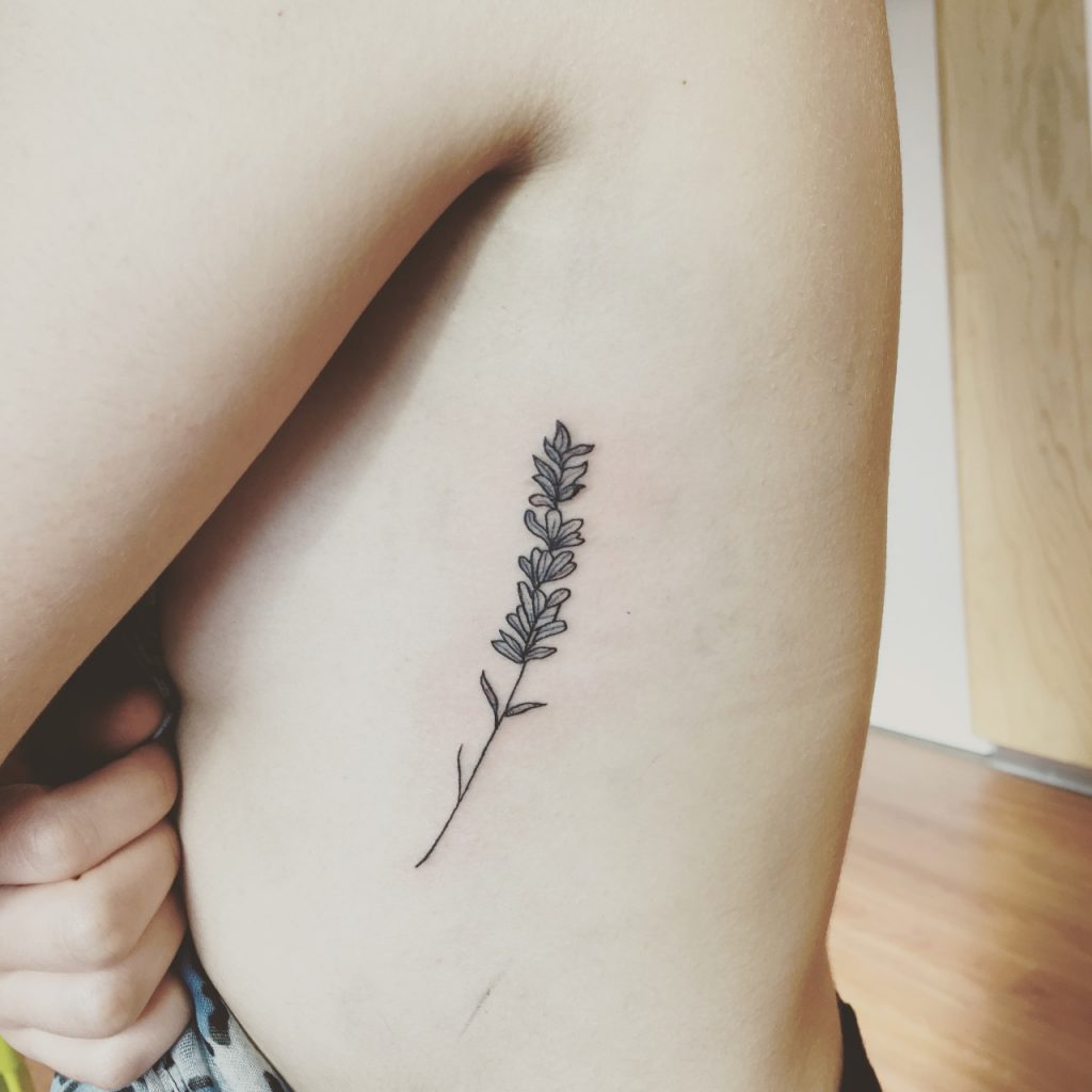 Black lavender flower tattoo on the left rib cage by dabytz