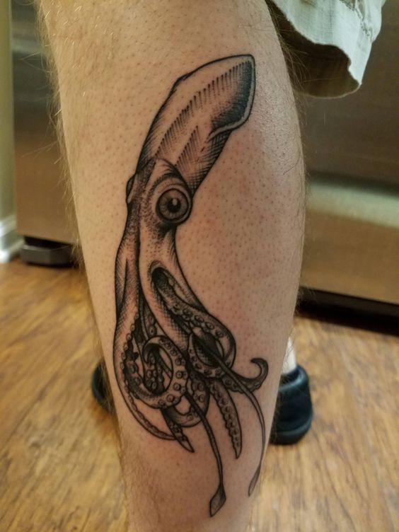 Black squid tattoo on the left calf