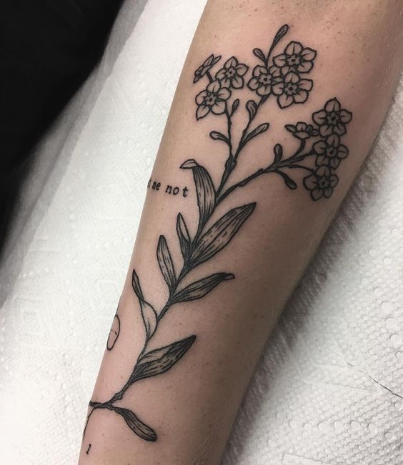 Blackwork forget me not tattoo on the arm