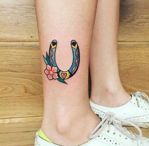 Colorful horseshoe tattoo on the right ankle