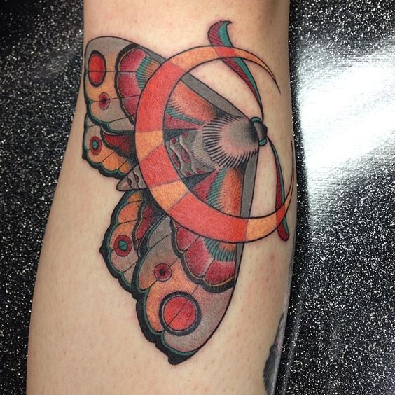 Colorful moth and crescent moon tattoo