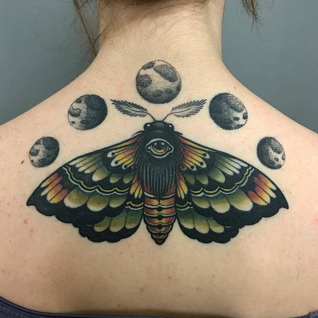 Colorful moth and moon phases tattoo on the calf by jacob mcgee