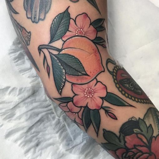 Colorful peach tattoo on the arm