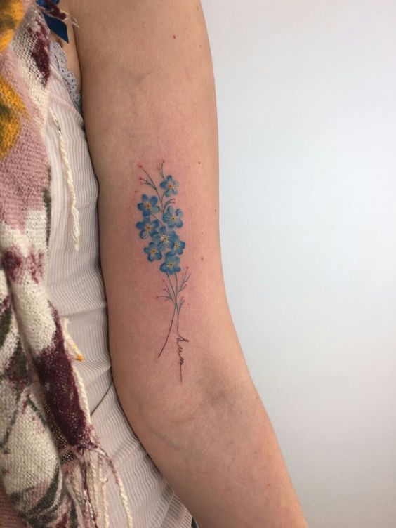 Delicate forget me not tattoo on the left arm