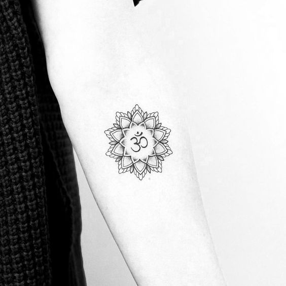 Delicate mandala and om tattoo on the inner forearm