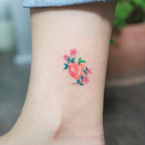 Delicate peach and flowers tattoo