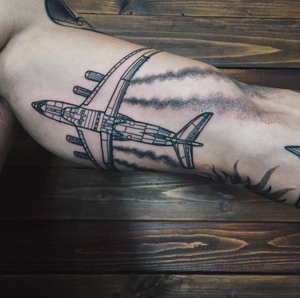 Detailed aircraft tattoo with the contrails
