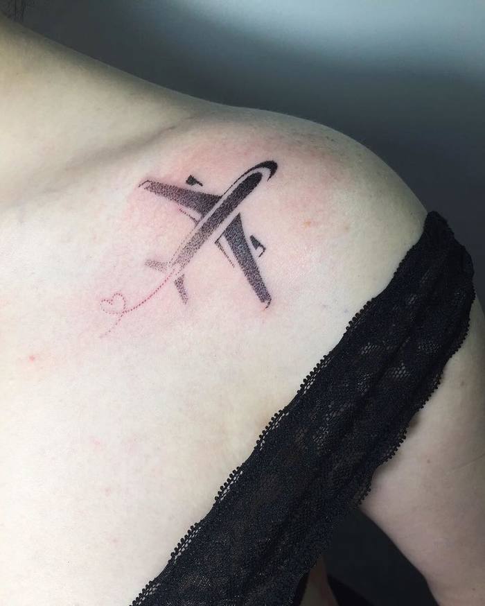 Dotwork airplane tattoo with a heart shaped contrail