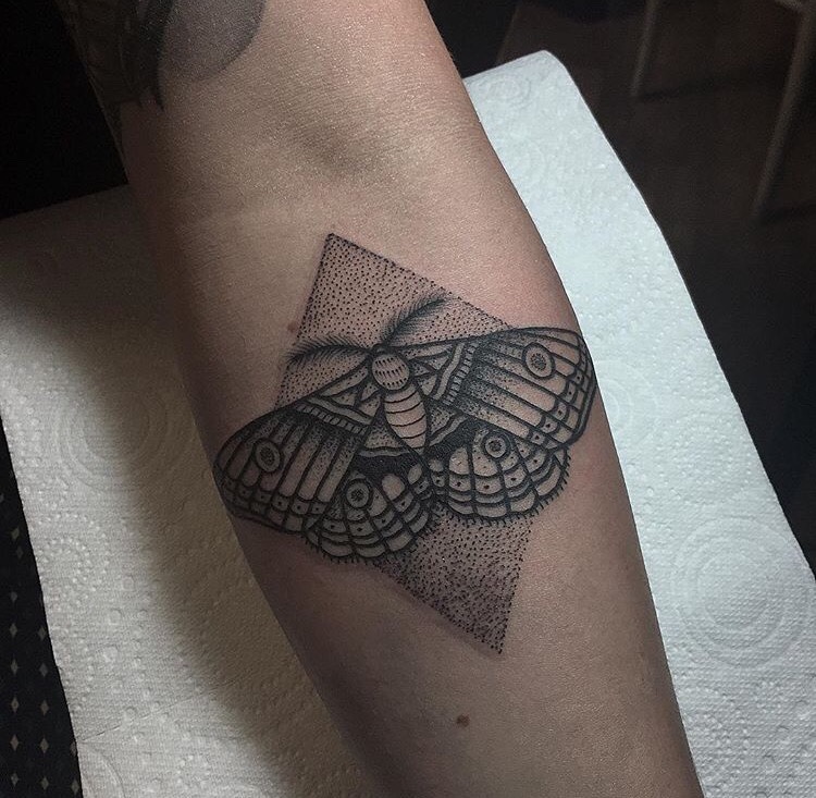 Dotwork style moth and rhombus tattoo on the forearm
