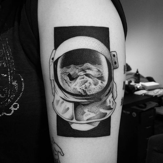 Dotwork style negative space astronaut helmet tattoo by matt pettis
