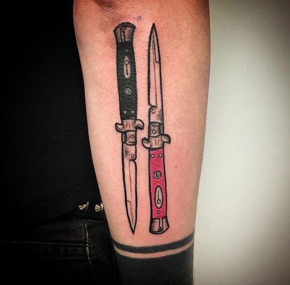 Double switchblade tattoo on the forearm