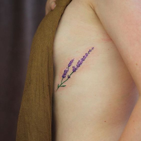 Elegant tattoo of a lavender under the left breast