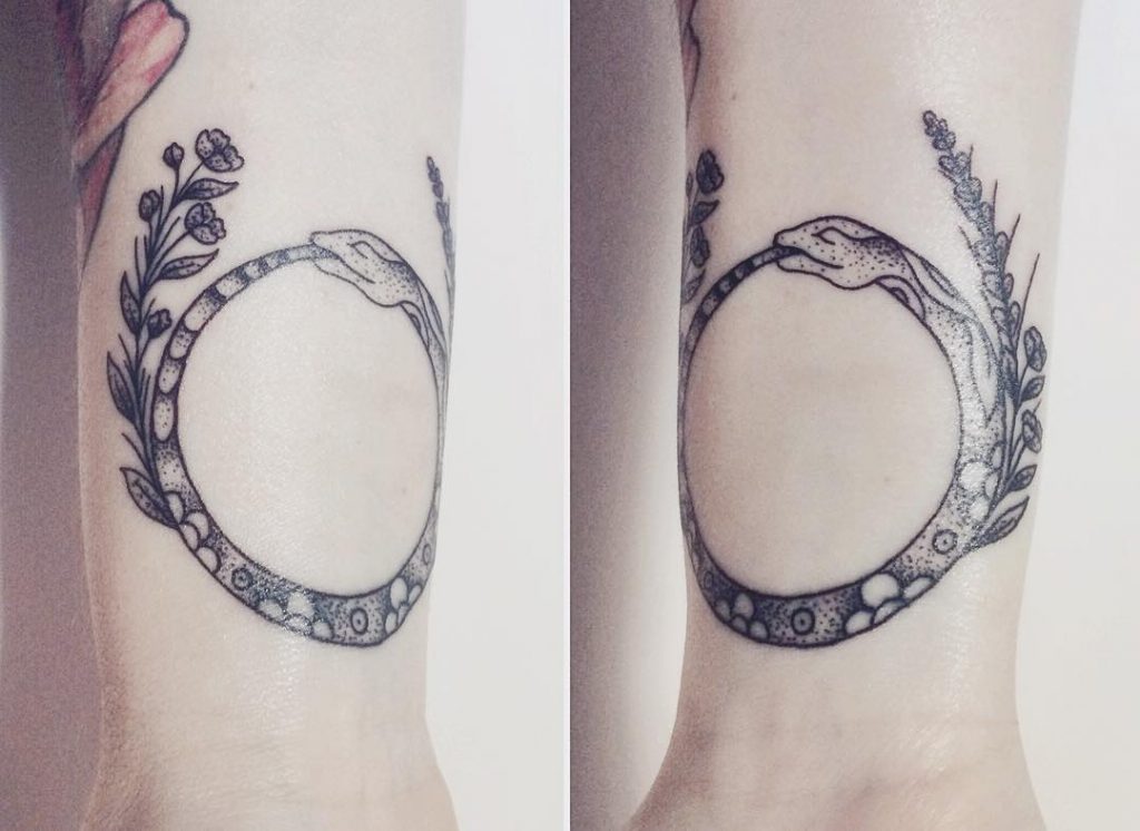 Flower and ouroboros tattoo