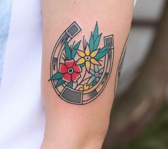 Good luck horseshoe tattoo with the flowers