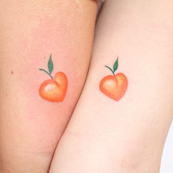 Heart shaped matching peach tattoos