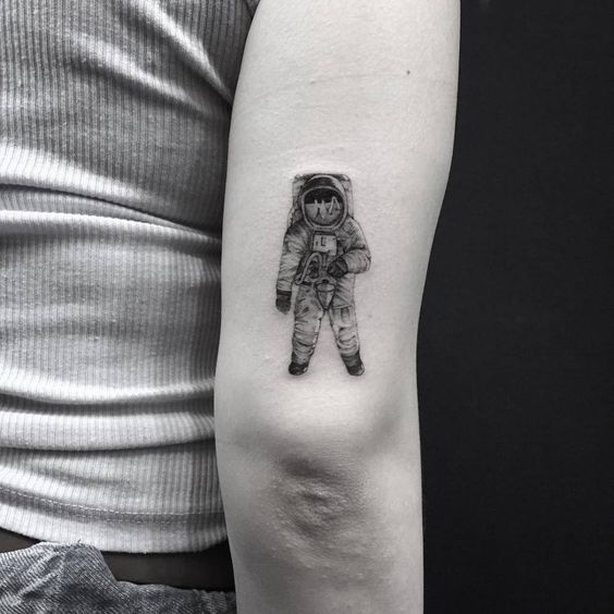 Hyper realistic neil armstrong tattoo on the back of the right arm