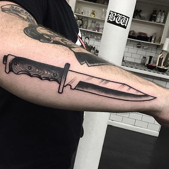 Knife tattoo on the right forearm